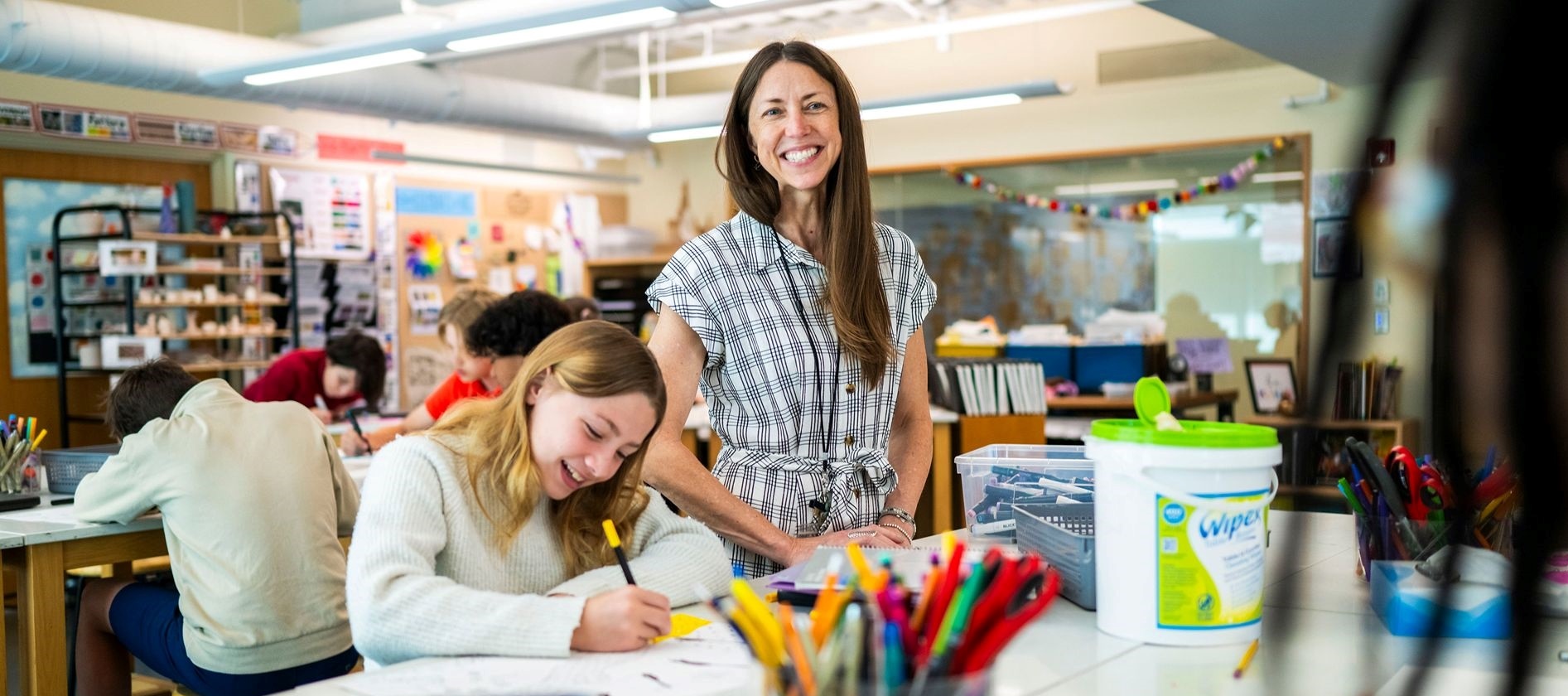 Teacher with students in a visual arts class at SLS.