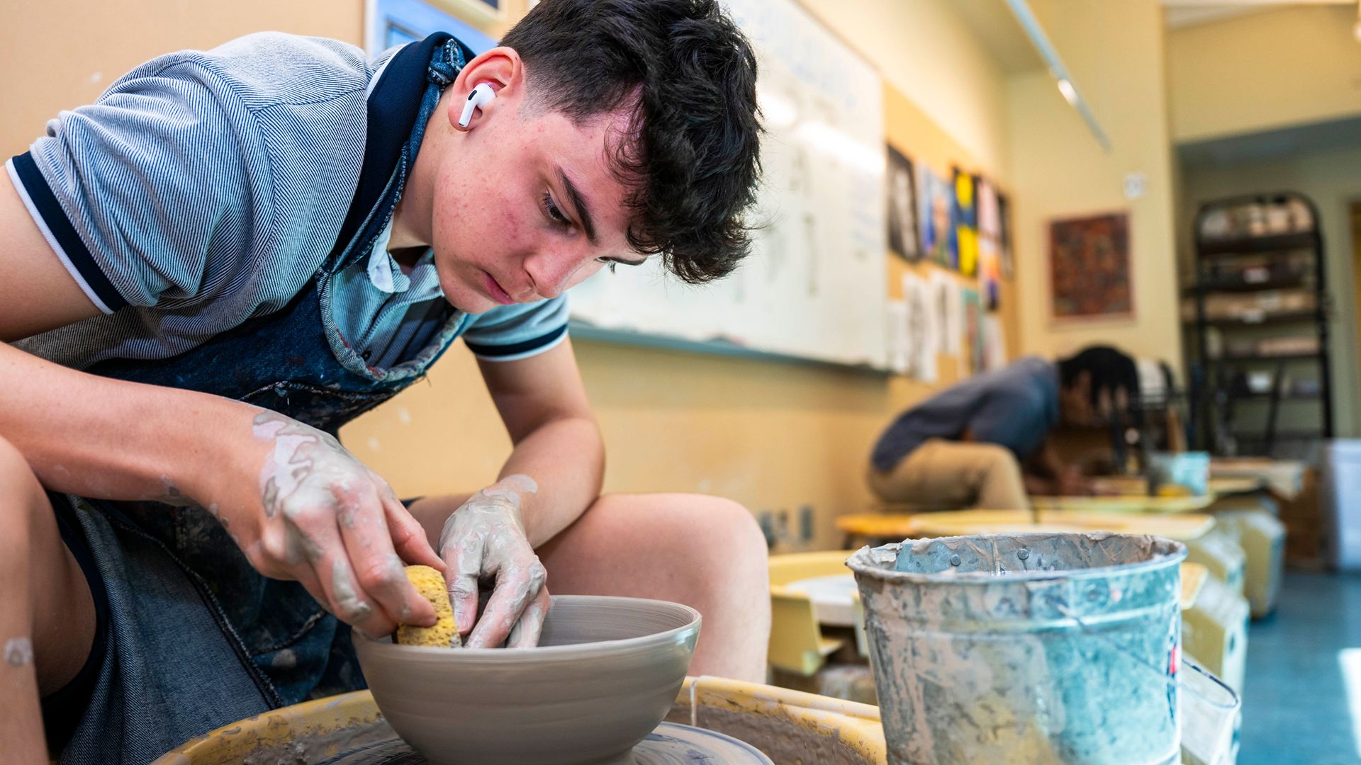 Upper schools students in visual arts class making pottery at SLS.